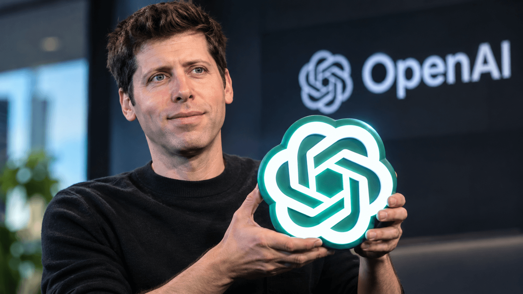 160 caracteres e não 60. Sam Altman segura a logo iluminada do ChatGPT em um escritório moderno da OpenAI, com iluminação cinematográfica e ambiente tecnológico ao fundo.